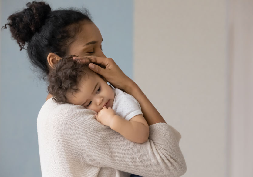 caring biracial mom hug